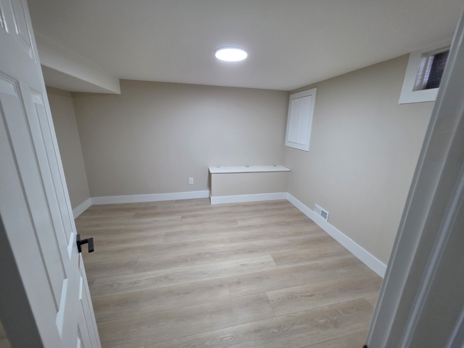 Completed basement renovation with new flooring and finish work